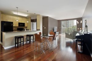 An open-plan living and kitchen area with hardwood flooring.